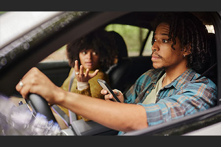 passenger telling a driver to stop texting and driving