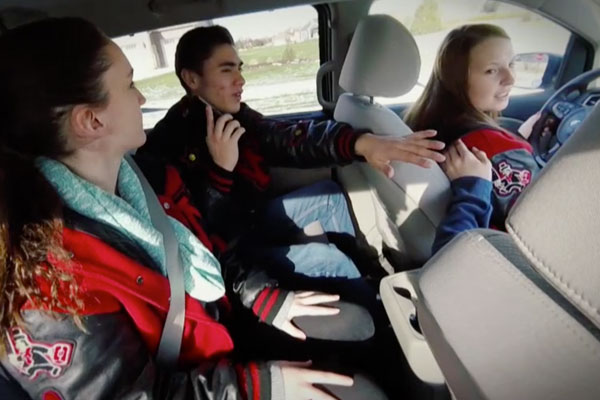 a group of teens in a car talking to each other
