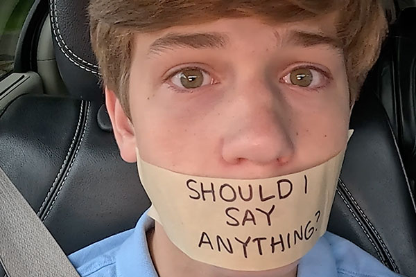 a teen in a car with tape over his mouth that reads should i say something