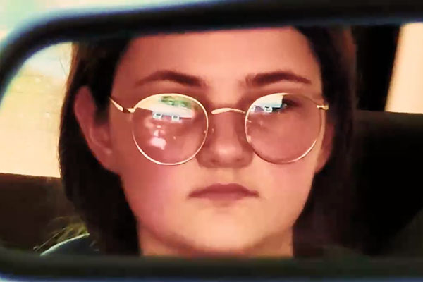 teen in a rearview mirror