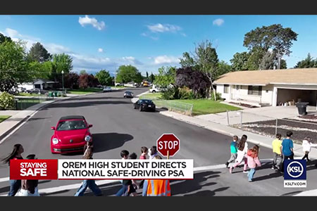 suburban area with a car and students crossing the street