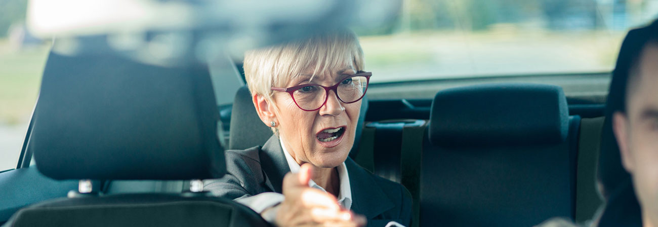 woman in a car not happy with the driver and speaking up