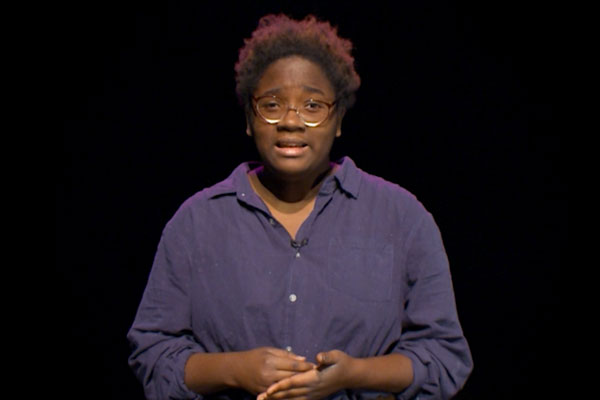 an african american teen with a black background