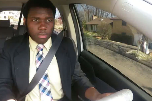 an african american young man driving a car