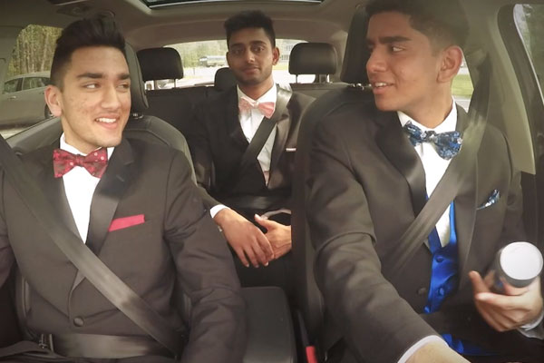 3 guys in a car in black tie dress smiling