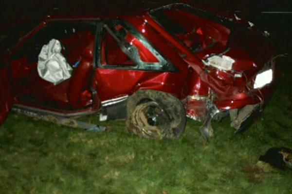 a destroyed red car after a crash